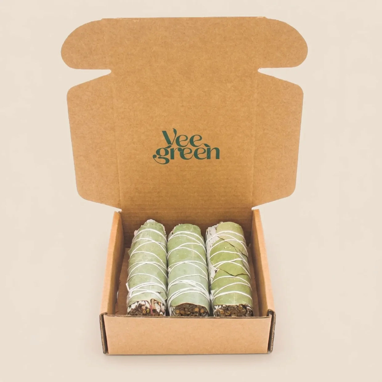 Vue de face d'un coffret ouvert présentant 3 bâtons de sauge blanche et eucalyptus sur fond neutre et épuré - Myvelyshop